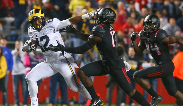 Oct 8, 2016; Piscataway, NJ, USA; Michigan Wolverines running back Chris Evans (12) runs with the ball while avoiding a tackle attempt by Rutgers Scarlet Knights defensive back K.J. Gray (17) during the second half at High Points Solutions Stadium. Michigan defeated Rutgers 78-0. Photo Credit: Ed Mulholland-USA TODAY Sports