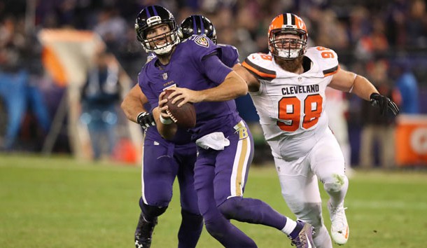 Nov 10, 2016; Baltimore, MD, USA; Baltimore Ravens quarterback Joe Flacco (5) runs from defensive pressure from Cleveland Browns defensive lineman Jamie Meder (98) at M&T Bank Stadium. Photo Credit: Mitch Stringer-USA TODAY Sports