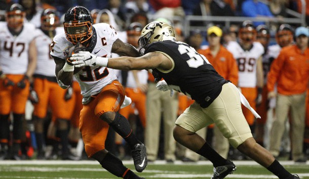 Dec 29, 2016; San Antonio, TX, USA; Oklahoma State Cowboys running back Chris Carson (32) runs the ball against the defense of Colorado Buffaloes linebacker Rick Gamboa (32, right) during the second half at Alamodome. Photo Credit: Soobum Im-USA TODAY Sports