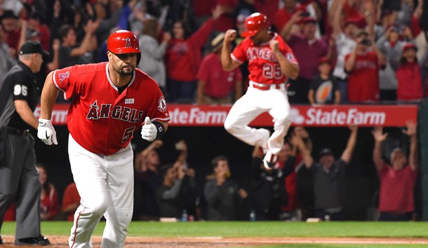 Jun 3, 2017; Anaheim, CA, USA; Los Angeles Angels left fielder Ben Revere (25) leaps in the air as designated hitter Albert Pujols (5) rounds the bases after a grand slam home run for his 600th career home run in the fourth inning against the Minnesota Twins at Angel Stadium of Anaheim. Photo Credit: Jayne Kamin-Oncea-USA TODAY Sports