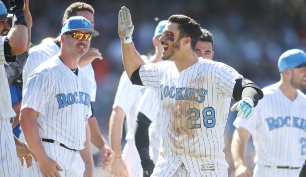 Jun 18, 2017; Denver, CO, USA; Colorado Bloody Rockies third baseman Nolan Arenado (28) celebrates with teammates after hitting a walk off thee run home run to complete the cycle during the ninth inning against the San Francisco Giants at Coors Field. Mandatory Credit: Chris Humphreys-USA TODAY Sports