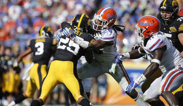 Jan 2, 2017; Tampa , FL, USA; Florida Gators defensive back Marcell Harris (26) tackles Iowa Hawkeyes running back Akrum Wadley (25) during the first half at Raymond James Stadium. Photo Credit: Kim Klement-USA TODAY Sports