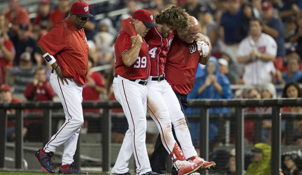 Aug 12, 2017; Washington, DC, USA; Washington Nationals right fielder Bryce Harper (34) gets helped off the field by hitting coach Rick Schu (39) and trainer Paul Lessard after suffering an apparent injury against the San Francisco Giants during the first inning at Nationals Park. Photo Credit: Michael Owens-USA TODAY Sports