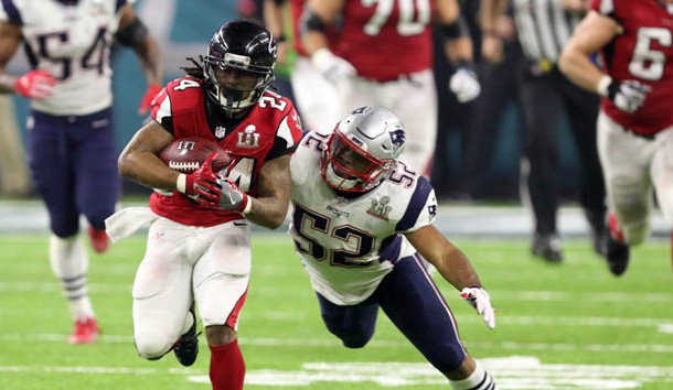 Feb 5, 2017; Houston, TX, USA; Atlanta Falcons running back Devonta Freeman (24) carries the ball past New England Patriots outside linebacker Elandon Roberts (52) in the fourth quarter during Super Bowl LI at NRG Stadium. Mandatory Credit: Eric Seals-USA TODAY Sports