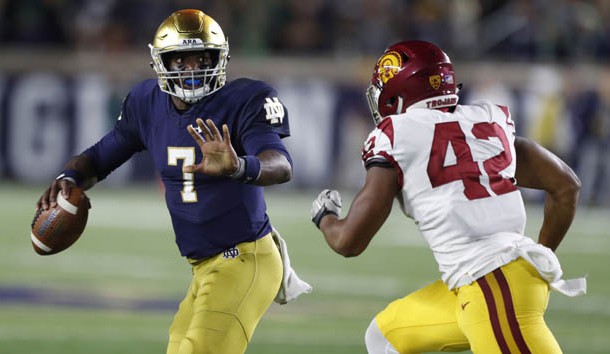 Oct 21, 2017; South Bend, IN, USA; Notre Dame Fighting Irish quarterback Brandon Wimbush (7) scrambles out of the pocket against Southern California Trojans linebacker Uchenna Nwosu (42) at Notre Dame Stadium. Photo Credit: Brian Spurlock-USA TODAY Sports