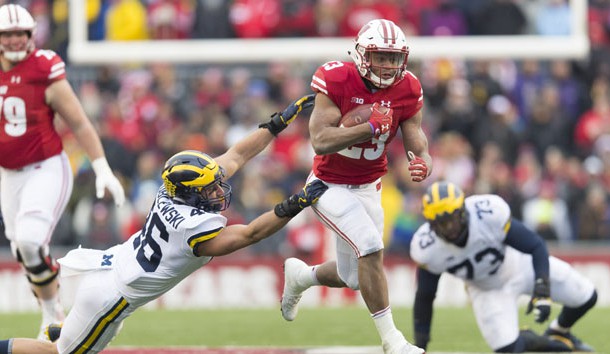 Jonathan Taylor (23) rushes with the football during the fourth quarter against the Michigan Wolverines at Camp Randall Stadium last season. Photo Credit: Jeff Hanisch-USA TODAY Sports