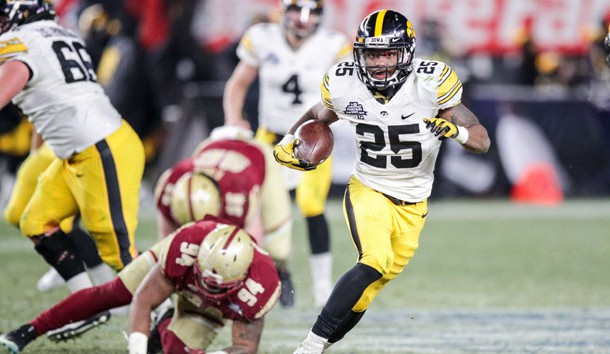 Dec 27, 2017; Bronx, NY, USA; Iowa Hawkeyes running back Akrum Wadley (25) rushes against Boston College Eagles defensive tackle Noa Merritt (94) during the second half of the 2017 Pinstripe Bowl at Yankee Stadium. Photo Credit: Vincent Carchietta-USA TODAY Sports