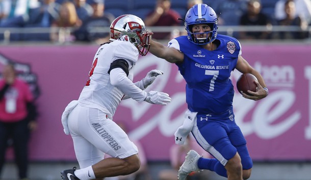 Dec 16, 2017; Orlando, FL, USA; Georgia State Panthers quarterback Conner Manning (7) stiff arms Western Kentucky Hilltoppers defensive back Devon Key (2) during the second quarter in the 2017 Cure Bowl at Camping World Stadium. Photo Credit: Reinhold Matay-USA TODAY Sports