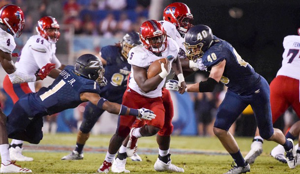 Dec 19, 2017; Boca Raton, FL, USA; Florida Atlantic Owls running back Devin Singletary (5) carries the ball against Akron Zips cornerback Alvin Davis (1) in the 2017 Boca Raton Bowlagainst the Akron Zips at FAU Stadium. Photo Credit: Steve Mitchell-USA TODAY Sports