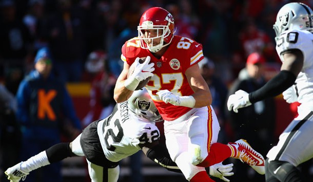 Dec 10, 2017; Kansas City, MO, USA; Kansas City Chiefs tight end Travis Kelce (87) runs against Oakland Raiders safety Karl Joseph (42) and linebacker Nicholas Morrow (50) in the first half at Arrowhead Stadium. Photo Credit: Jay Biggerstaff-USA TODAY Sports