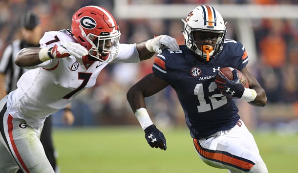 Nov 11, 2017; Auburn, AL, USA; Auburn Tigers wide receiver Eli Stove (12) carries up the field against Georgia Bulldogs linebacker Lorenzo Carter (7) during the third quarter at Jordan-Hare Stadium. Photo Credit: John David Mercer-USA TODAY Sports