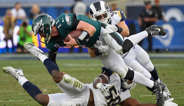 Dec 10, 2017; Los Angeles, CA, USA; Philadelphia Eagles quarterback Carson Wentz (11) is tackled by Los Angeles Rams inside linebacker Bryce Hager (54) and Los Angeles Rams linebacker Samson Ebukam (50) during the third quarter at Los Angeles Memorial Coliseum. Photo Credit: Robert Hanashiro-USA TODAY Sports