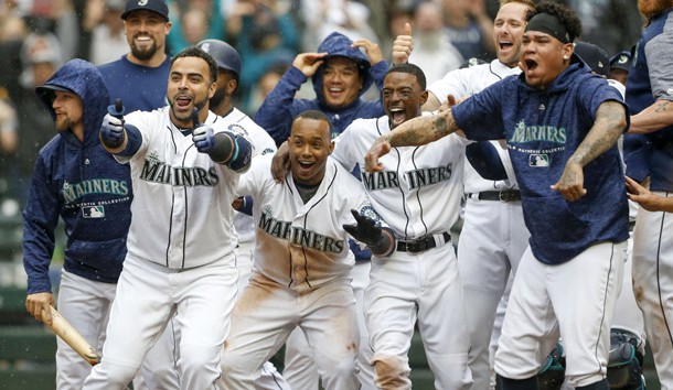 Jun 13, 2018; Seattle, WA, USA; Seattle Mariners designated hitter Nelson Cruz (23, left), shortstop Jean Segura (2), second baseman Dee Gordon (9) and starting pitcher Felix Hernandez (34, right) wait at home plate following a walk-off two-run homer by right fielder Mitch Haniger (17, not pictured) against the Los Angeles Angels during the ninth inning at Safeco Field. Segura scored on the hit. Seattle defeated Los Angeles, 8-6. Photo Credit: Joe Nicholson-USA TODAY Sports