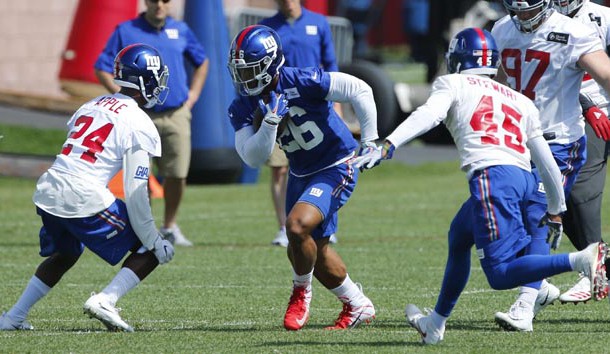 May 21, 2018; East Rutherford, NJ, USA; New York Giants running back Saquon Barkley (26) rushes against cornerback Eli Apple (24) and defensive back Orion Stewart (45) during practice at Quest Diagnostic Training Center. Photo Credit: Noah K. Murray-USA TODAY Sports