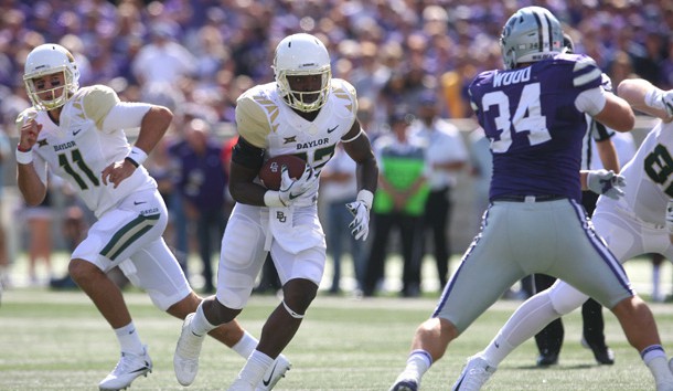 Sep 30, 2017; Manhattan, KS, USA; Baylor Bears running back Terence Williams (22) looks for room to run against Kansas State Wildcats defensive end Tanner Wood (34) during first quarter action at Bill Snyder Family Stadium. Photo Credit: Scott Sewell-USA TODAY Sports