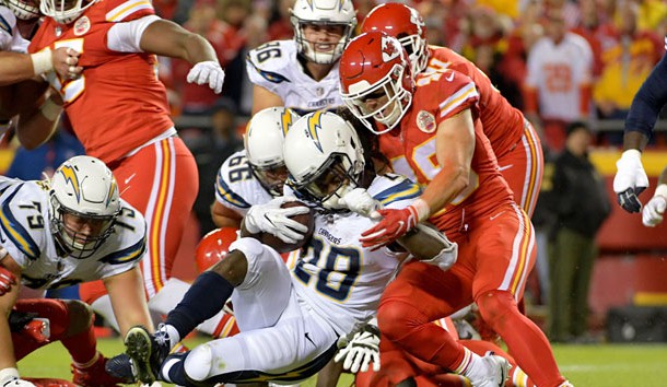 Dec 16, 2017; Kansas City, MO, USA; Los Angeles Chargers running back Melvin Gordon (28) runs the ball and is tackled by Kansas City Chiefs strong safety Daniel Sorensen (49) during the first half at Arrowhead Stadium. Mandatory Credit: Denny Medley-USA TODAY Sports