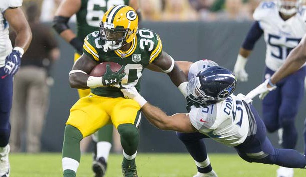 Aug 9, 2018; Green Bay, WI, USA; Green Bay Packers running back Jamaal Williams (30) is tackled by Tennessee Titans linebacker Will Compton (51) during the second quarter at Lambeau Field. Photo Credit: Jeff Hanisch-USA TODAY Sports