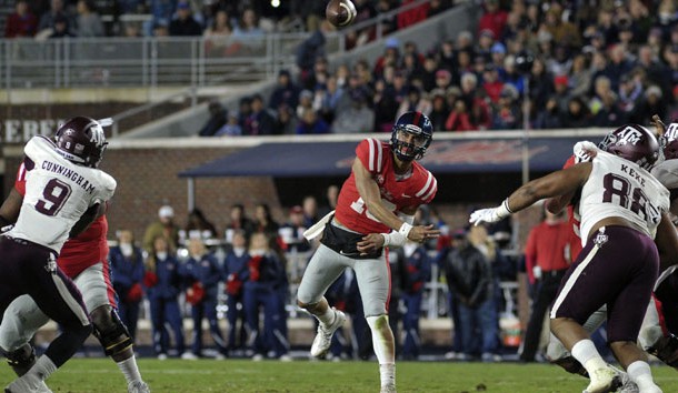 Nov 18, 2017; Oxford, MS, USA; Mississippi Rebels quarterback Jordan Ta'amu (10) passes the ball against Texas A&M Aggies defensive lineman Qualen Cunningham (9) during the first half at Vaught-Hemingway Stadium. Photo Credit: Justin Ford-USA TODAY Sports