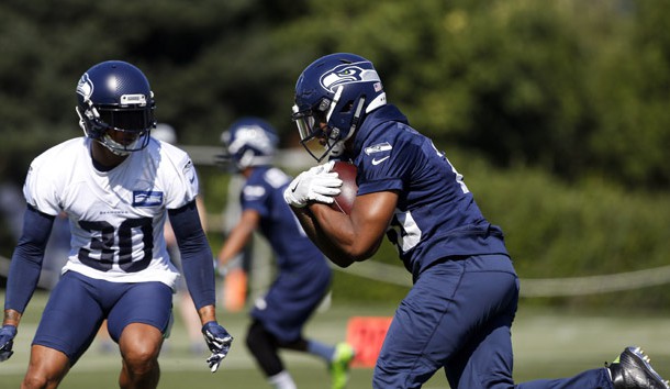 Jul 26, 2018; Renton, WA, USA; Seattle Seahawks running back Rashaad Penny (20) rushes against strong safety Bradley McDougald (30) during a training camp practice at the Virginia Mason Athletic Center. Photo Credit: Joe Nicholson-USA TODAY Sports