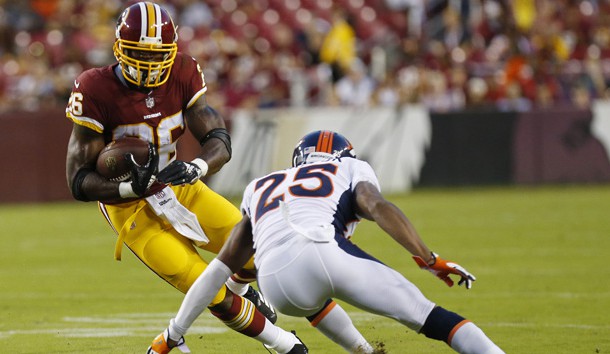 Aug 24, 2018; Landover, MD, USA; Washington Redskins running back Adrian Peterson (26) carries the ball as Denver Broncos defensive back Chris Harris (25) attempts the tackle in the first quarter at FedEx Field. Photo Credit: Geoff Burke-USA TODAY Sports