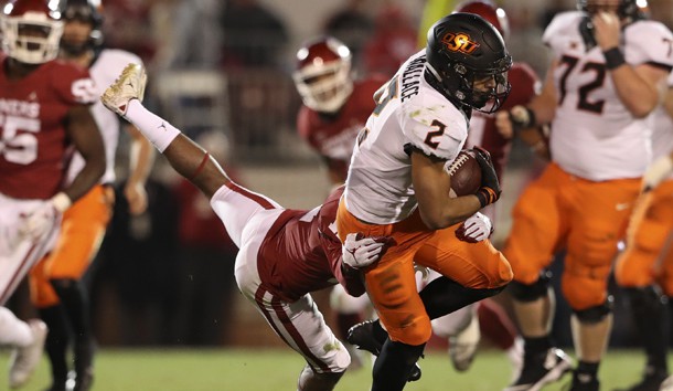Nov 10, 2018; Norman, OK, USA; Oklahoma State Cowboys wide receiver Tylan Wallace (2) is tackled by Oklahoma Sooners cornerback Parnell Motley (11) during the second half at Gaylord Family - Oklahoma Memorial Stadium. Photo Credit: Kevin Jairaj-USA TODAY Sports
