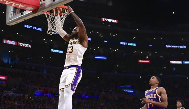 Dec 2, 2018; Los Angeles, CA, USA; Los Angeles Lakers forward LeBron James (23) slam dunks in the third quarter against the Phoenix Suns at Staples Center.Right is Phoenix Suns guard De'Anthony Melton (14). Photo Credit: Robert Hanashiro-USA TODAY Sports