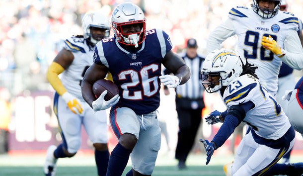 Jan 13, 2019; Foxborough, MA, USA; New England Patriots running back Sony Michel (26) rushes against Los Angeles Chargers defensive back Rayshawn Jenkins (23) during the second quarter in an AFC Divisional playoff football game at Gillette Stadium. Photo Credit: David Butler II-USA TODAY Sports