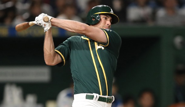 Mar 17, 2019; Tokyo, Japan; Oakland Athletics first baseman Matt Olson (28) follows-through on a base hit during the third inning against the Nippon Ham Fighters at Tokyo Dome. Photo Credit: Darren Yamashita-USA TODAY Sports