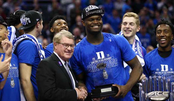 Mar 16, 2019; Charlotte, NC, USA; ACC Commissioner John Swofford presents Duke Blue Devils forward Zion Williamson (1) with the tournament MVP trophy in the ACC conference tournament at Spectrum Center. Photo Credit: Jeremy Brevard-USA TODAY Sports