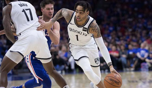 Apr 13, 2019; Philadelphia, PA, USA; Brooklyn Nets guard D'Angelo Russell (1) dribbles past Philadelphia 76ers guard T.J. McConnell (12) during the fourth quarter in game one of the first round of the 2019 NBA Playoffs at Wells Fargo Center. Photo Credit: Bill Streicher-USA TODAY Sports