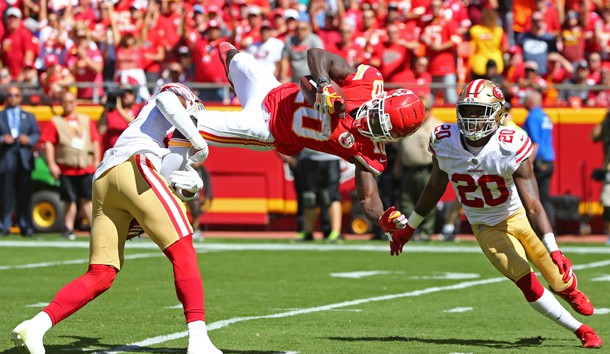 Sep 23, 2018; Kansas City, MO, USA; Kansas City Chiefs wide receiver Tyreek Hill (10) catches a pass as San Francisco 49ers cornerbacks Jimmie Ward (20) and Adrian Colbert (27) defend in the first half at Arrowhead Stadium. Photo Credit: Jay Biggerstaff-USA TODAY Sports