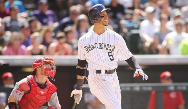 Jul 26, 2015; Denver, CO, USA; Colorado Rockies right fielder Carlos Gonzalez (5) hits a home run during the third inning against the Cincinnati Reds at Coors Field. Mandatory Credit: Chris Humphreys-USA TODAY Sports