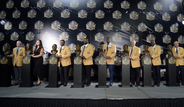 Aug 8, 2015; Canton, OH, USA; Enshrinees Bill Polian and Sydney Seau (representing father Junior Seau), Jerome Bettis and Will Shields and Charles Haley and Mick Tingelhoff and Tim Brown and Ron Wolf pose with their busts during the 2015 Pro Football Hall of Fame enshrinement at Tom Benson Hall of Fame Stadium. Photo Credit: Kirby Lee-USA TODAY Sports