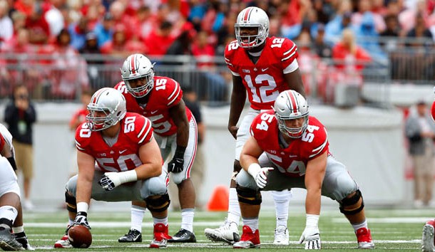 Sep 19, 2015; Columbus, OH, USA; Ohio State Buckeyes offensive lineman Jacoby Boren (50) and Billy Price (54) with Buckeyes quarterback Cardale Jones (12) and running back Ezekiel Elliott (15) in the backfield during the game versus the Northern Illinois Huskies at Ohio Stadium. Ohio State won the game 20-13. Mandatory Credit: Joe Maiorana-USA TODAY Sports