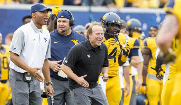 Sep 26, 2015; Morgantown, WV, USA; West Virginia Mountaineers head coach Dana Holgorsen celebrates with his players after scoring a touchdown against the Maryland Terrapins during the second quarter at Milan Puskar Stadium. Mandatory Credit: Ben Queen-USA TODAY Sports