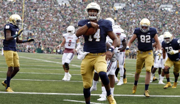 Sep 26, 2015; South Bend, IN, USA; Notre Dame Fighting Irish quarterback DeShone Kizer (14) runs the ball in for a touchdown against the Massachusetts Minutemen at Notre Dame Stadium. Mandatory Credit: Brian Spurlock-USA TODAY Sports