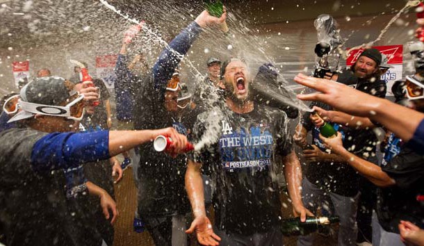 Sep 29, 2015; San Francisco, CA, USA; Los Angeles Dodgers teammates spray champagne and beer on starting pitcher Clayton Kershaw (22) in the locker room after clinching the NL west after a win against the San Francisco Giants at AT&T Park.The Los Angeles Dodgers defeated the San Francisco Giants 8-0. Mandatory Credit: Kelley L Cox-USA TODAY Sports