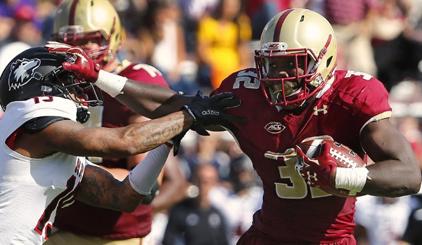 Sep 26, 2015; Boston, MA, USA; Boston College running back Jon Hilliman (32) stiff arms Northern Illinois cornerback Shawun Lurry (19) on his way to a touchdown during the second half of Boston College's 17-14 win over Northern Illinois at Alumni Stadium. Mandatory Credit: Winslow Townson-USA TODAY Sports