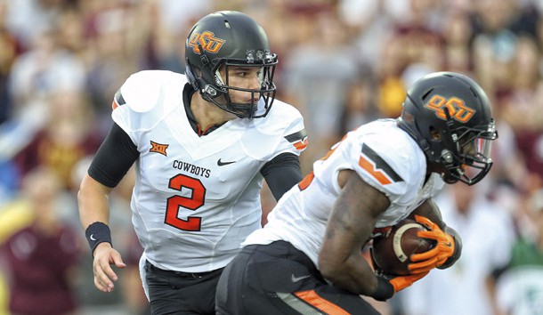 Sep 3, 2015; Mount Pleasant, MI, USA;  Oklahoma State Cowboys quarterback Mason Rudolph (2) hands the ball off to running back Todd Mays (22) during the 1st quarter against the Central Michigan Chippewas at Kelly/Shorts Stadium. Mandatory Credit: Mike Carter-USA TODAY Sports