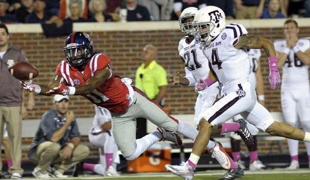 Oct 24, 2015; Oxford, MS, USA; Mississippi Rebels wide receiver Markell Pack (11) attempts to catch a pass against Texas A&M Aggies defensive back Noel Ellis (4) and Texas A&M Aggies defense back Brandon Williams (21) during the game at Vaught-Hemingway Stadium. Mandatory Credit: Justin Ford-USA TODAY Sports