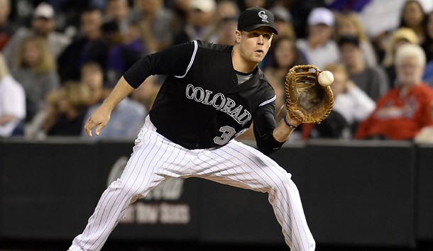 Sep 18, 2015; Denver, CO, USA; Colorado Rockies first baseman Justin Morneau (33)  pulls in a catch for an out in the eighth inning against the San Diego Padres at Coors Field. Mandatory Credit: Ron Chenoy-USA TODAY Sports