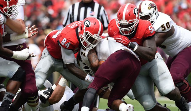 Sep 5, 2015; Athens, GA, USA; Louisiana Monroe Warhawks running back DeVontae McNeal (28) is tackled by Georgia Bulldogs linebacker Leonard Floyd (84) and defensive tackle Sterling Bailey (58) during the second quarter at Sanford Stadium. Mandatory Credit: Dale Zanine-USA TODAY Sports