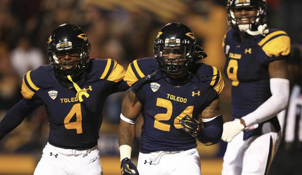 Sep 19, 2015; Toledo, OH, USA; Toledo Rockets wide receiver Corey Jones (4),  running back Damion Jones-Moore (24) and  wide receiver Alonzo Russell (9) celebrate after the game winning touchdown during the fourth at Glass Bowl. Toledo Rockets defeated Iowa State Cyclones 30-23. Mandatory Credit: Andrew Weber-USA TODAY Sports