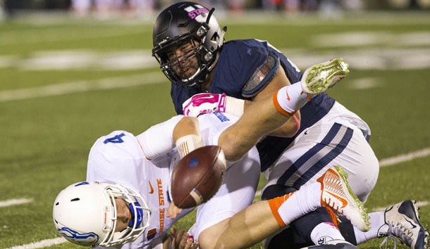 Oct 16, 2015; Logan, UT, USA; Boise State Broncos quarterback Brett Rypien (4) fumbles the ball forced by Utah State Aggies defensive end Ricky Ali'ifua (95) at Romney Stadium. Mandatory Credit: Rob Gray-USA TODAY Sports