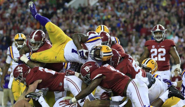 Nov 7, 2015; Tuscaloosa, AL, USA; LSU Tigers running back Leonard Fournette (7) leaps over Alabama Crimson Tide defense during the fourth quarter at Bryant-Denny Stadium. Alabama won 30-16. Mandatory Credit: Marvin Gentry-USA TODAY Sports