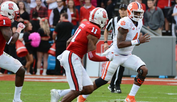 Oct 31, 2015; Raleigh, NC, USA; Clemson Tigers quarterback Deshaun Watson (4) runs during the first half as North Carolina State Wolfpack cornerback Justin Burris (11) pursues at Carter Finley Stadium. Mandatory Credit: Rob Kinnan-USA TODAY Sports