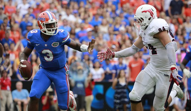 Nov 21, 2015; Gainesville, FL, USA; Florida Gators quarterback Treon Harris (3) scrambles against Florida Atlantic Owls defensive lineman Hunter Snyder (94) during the second quarter at Ben Hill Griffin Stadium. Mandatory Credit: Kim Klement-USA TODAY Sports