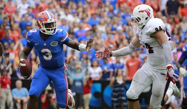 Nov 21, 2015; Gainesville, FL, USA; Florida Gators quarterback Treon Harris (3) scrambles against  Florida Atlantic Owls defensive lineman Hunter Snyder (94) during the second quarter at Ben Hill Griffin Stadium. Mandatory Credit: Kim Klement-USA TODAY Sports