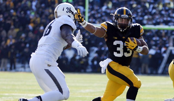 Nov 21, 2015; Iowa City, IA, USA; Iowa Hawkeyes running back Jordan Canzeri (33) is pursued by Purdue Boilermakers linebacker Danny Ezechukwu (36) during the second quarter at Kinnick Stadium. Mandatory Credit: Reese Strickland-USA TODAY Sports