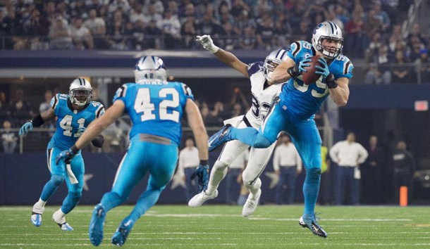 Nov 26, 2015; Arlington, TX, USA; Carolina Panthers middle linebacker Luke Kuechly (59) intercepts a pass thrown by Dallas Cowboys quarterback Tony Romo (not pictured) and scores a touchdown during the second quarter of an NFL game on Thanksgiving at AT&T Stadium. Mandatory Credit: Jerome Miron-USA TODAY Sports
